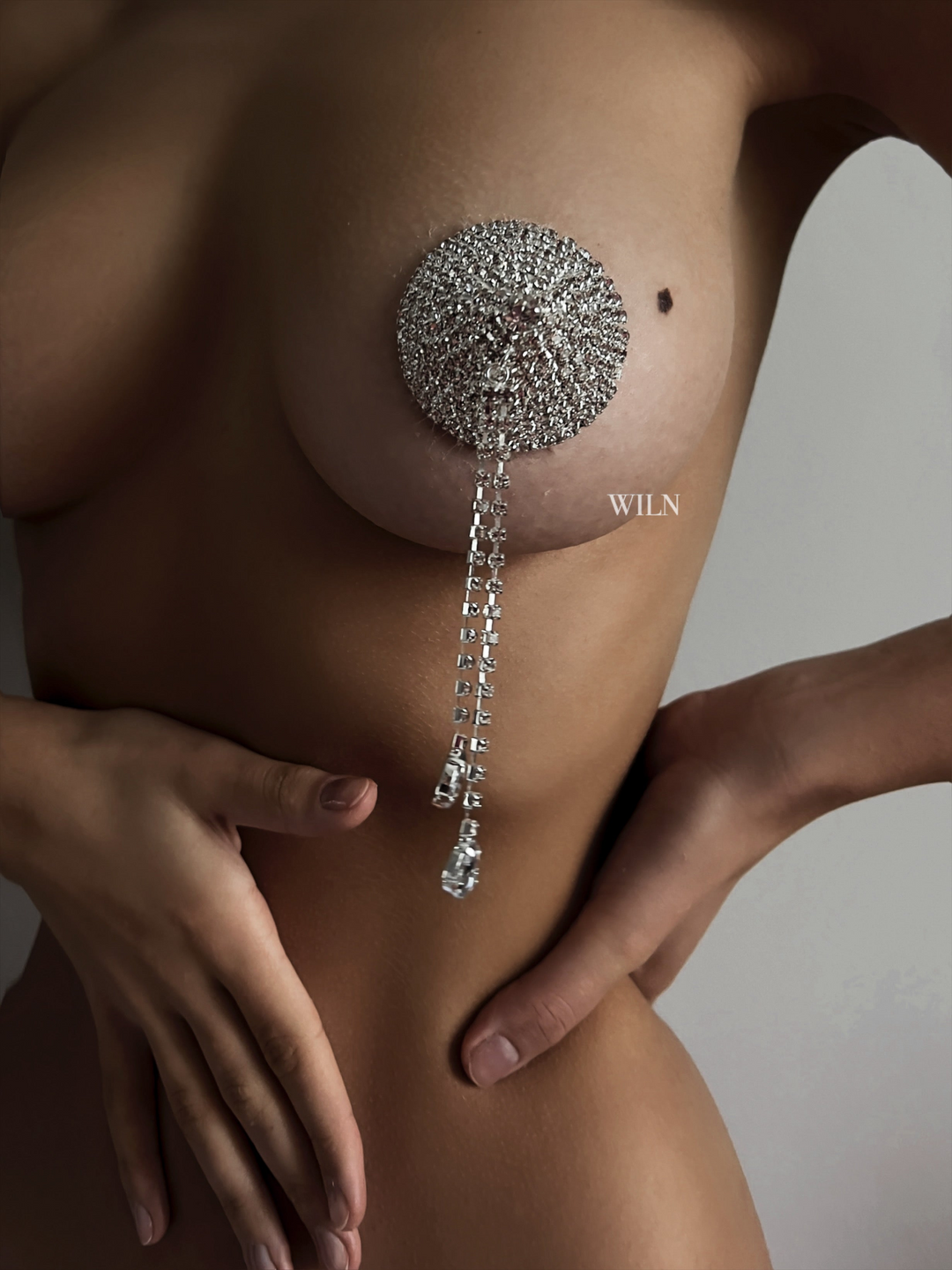 Rhinestone nipple covers with tassel detail close up on the model 